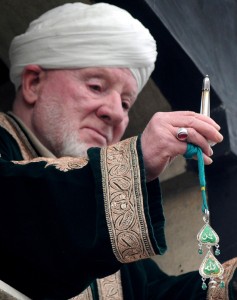 Cleric Peer Hisam-u-Din-Banday displays a holy relic believed to contain a hair from the beard of Prophet Mohammed during Friday following Eid-e-Milad-un-Nabi prayers at Hazratbal shrine in Srinagar.