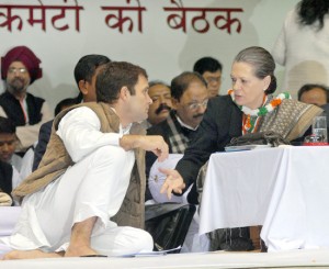Congress president Sonia Gandhi interacting with party vice president Rahul Gandhi at the AICC meeting in New Delhi on Friday. (UNI)