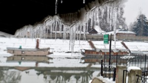 Long Icicles dangling from the roof of a house on the banks of Jhelum river in Srinagar on Friday. -Excelsior/Amin War