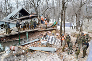 Civil Defence workers and security personnel trying to recover the body of a militant killed by Army in Qazigund on Monday. -Excelsior/Sajad Dar