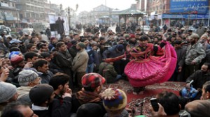A Kashmir folk dancer performs a show to spread awareness about road safety during a program organized by Traffic police at Lal Chowk in Srinagar on Monday. -Excelsior/Amin War