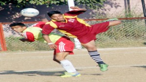 Footballers in acrobatic style trying to get hold of the ball in a match at GGM Science College Football ground in Jammu on Monday.-Excelsior/Rakesh