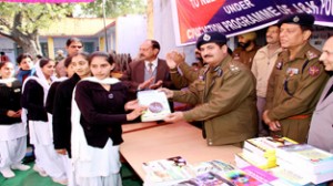 DIG Shakeel Ahmed Beig distributing books among deserving students on Thursday.