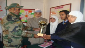 Winners of debate competition receiving trophy from chief guest on Thursday.