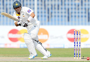 Pakistan batsman Ahmed Shehzad (R) plays a shot during the third day of the third and final cricket Test match against Sri Lanka at the Sharjah International Cricket Stadium.