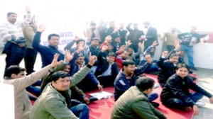 Employees of AIDS Control Society protesting at Jammu on Thursday.