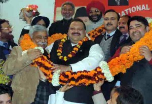 Devender Singh Rana being garlanded by party leaders at NC Headquarters in Jammu on Wednesday.