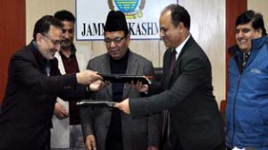 Copies of MoU being exchanged in the presence of Minister for Finance, Abdul Rahim Rather on Wednesday.