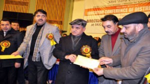 Deputy Chief Minister Tara Chand distributing order to a education volunteer at SKICC on Monday.