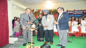 Commissioner KVS Avinash Dikshit lighting ceremonial lamp during awards ceremony at KV Gandhi Nagar.
