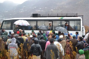 Passengers board cross-LoC bus at URI on Monday. —Excelsior/Aabid Nabi