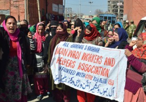 Members of Anganwadi Workers and Helpers Association shouting anti-government slogan during a protest in Srinagar on Monday.-Excelsior/ Amin War