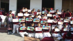 Participants of drawing competition posing for a group photograph at SNS Vidya Mandir in Jammu.
