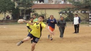 Handballer shoots during a match of State Handball Championship in Jammu on Wednesday.
