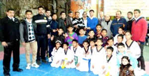 Players posing alongwith officials and dignitaries during concluding ceremony of 3rd Open J&K State Taekwondo Championship on Sunday.