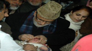 Ali Mohd Sagar administering polio drops to a child on Sunday.