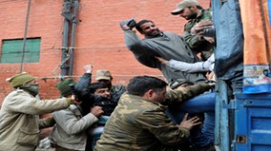PHE workers being packed in police vehicle during protest march in Srinagar.    —Excelsior/Amin War