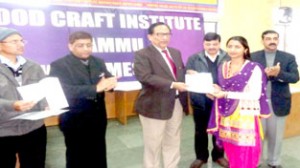 A woman entrepreneur being presented certificate by President CCI, Y V Sharma in a function at Jammu on Monday.