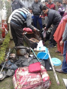 People inspecting household goods damaged in fire incident in village Gadwal. —Excelsior/Gautam