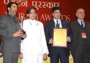 Union Minister for Tourism presenting National Tourism Award to J&K Tourism Minister GA Mir in a function at New Delhi.