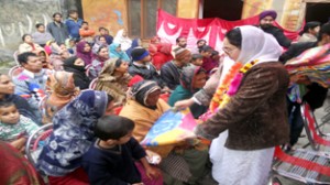 Dr Darakhshan Andrabi  distributing wollen blankets to deprived and poor sections of the society on Saturday.