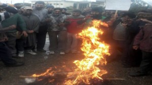 Oil tankers’ drivers and cleaners burning the effigy of State Transport Commissioner at Jammu on Saturday.