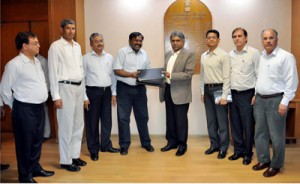 G Sai Prasad exchanging documents with P K Sinha after signing of MoU at New Delhi.