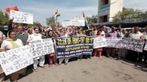 PoJK refugees protesting in front of Jammu Press Club on Tuesday. -Excelsior/ Rakesh