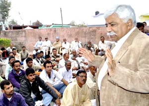 Minister for Planning Ajay Sadhotra addressing a public meeting on Monday.