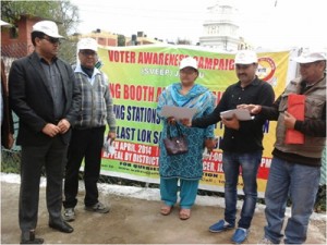 Officers and others during voter awareness campaign in Jammu on Friday.