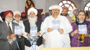 Mahant Manjit Singh, Housing Minister Raman Bhalla and PDP leader Rangil Singh releasing video of TRB Group at a function in Jammu on Wednesday.               Excelsior/ Rakesh