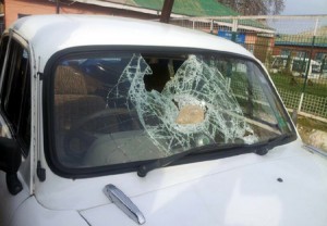A KU car damaged in stone pelting at Shopian on Tuesday.