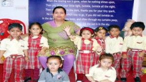 Children of First-Step Playway School posing alongwith Principal during annual day celebration.