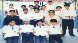 Students of SNS Vidya Mandir displaying certificates after qualifying the Belt Grading Test.