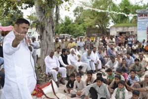 MP Madan Lal Sharma addressing a public gathering at a border village in district Kathua.
