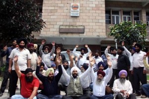 Transporters protesting outside IOC office at Jammu on Monday.
