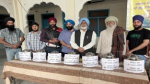 DGPC members and Sevadars of  Chand Nagar Gurdwara, displaying  pots carrying holy water from 7 ‘Sarovars’ at a press conference in Jammu. -Excelsior/ Rakesh