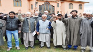 Panchs and Sarpanchs  of  Pulwama district  protesting over the killing of Sarpanch on Friday. -Excelsior/ Younis Khaliq 