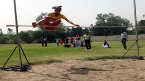 Young athletes displaying skill during high jump event of Inter-School Athletic Meet in Jammu. 