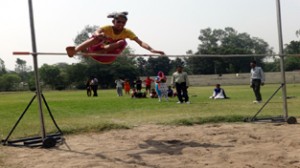 Young athletes displaying skill during high jump event of Inter-School Athletic Meet in Jammu. 