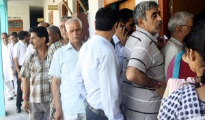 Migrants standing ina queue in front of a polling booth at Jagti to cast their vote on Wednesday. -Excelsior/Rakesh