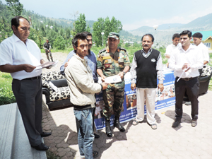 Commanding Officer, Rashtriya Rifles located at Bhadarwah distributing certificates and stipend among students.
