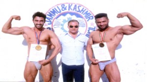 Bodybuilders Pushpinder and Sandeep posing alongwith Rajeev Charak.