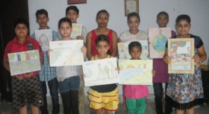Prize winners of painting competition organized by Nirvana Academy posing for a group photograph.