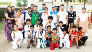 Medallists of District Udhampur in Taekwondo Championship posing for a group photograph. 