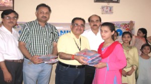 Zonal Head, SBI J&K Module, SK Kapoor distributing stationery items among students of Ved Mandir Bal Kendra at Jammu.