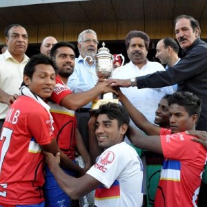 Air India Football Club players receiving winners trophy from Ministers, Raman Bhalla and Taj Mohi-ud-Din after lifting the Kashmir Invitational Football Cup title in Srinagar.