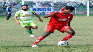 Players in action in the 6th match of Kashmir Invitation Football Cup 2014 at Polo Ground in Srinagar. -Excelsior/Amin War