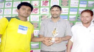 Kuldeep of Banaras Cricket Club being presented man of the match trophy in Doda.