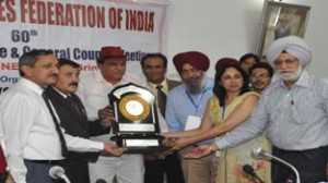 Speaker Mubarak Gul alongwith dignitaries from SGFI and DYSS receiving memento while releasing calendar of activities.